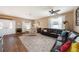 Spacious living room with hardwood floors, comfortable seating, and natural light at 5806 Candytuft Place, Land O Lakes, FL 34639