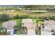Aerial view of a two story house with a large backyard and surrounding nature at 5806 Candytuft Place, Land O Lakes, FL 34639