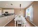 Bright dining area adjacent to the kitchen, featuring a farmhouse table and wood floors at 5806 Candytuft Place, Land O Lakes, FL 34639