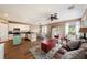 Open concept kitchen and living area with light cabinets, and a teal island at 5806 Candytuft Place, Land O Lakes, FL 34639