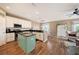 Modern kitchen with white cabinets, granite countertops, and a teal island at 5806 Candytuft Place, Land O Lakes, FL 34639