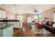 Open concept kitchen and living area with hardwood floors at 5806 Candytuft Place, Land O Lakes, FL 34639