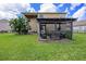Spacious backyard with screened patio and two-story house at 5806 Candytuft Place, Land O Lakes, FL 34639