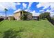 Large backyard with grassy area and two-story house at 5806 Candytuft Place, Land O Lakes, FL 34639