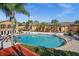 Community pool with surrounding lounge chairs at 1861 Toucan Way # 1203, Sarasota, FL 34232