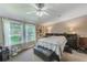 Bright bedroom with garden views and ceiling fan at 5104 S 66Th St, Tampa, FL 33619