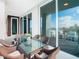 Relaxing balcony with glass-top table and wicker chairs at 920 N Osceola Ave # 703, Clearwater, FL 33755
