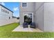 Private patio with two chairs and sliding glass door access at 19065 Malinche Loop, Spring Hill, FL 34610