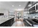 Modern kitchen boasts dark cabinetry, granite counters, and stainless steel appliances at 19065 Malinche Loop, Spring Hill, FL 34610