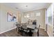 Bright dining room with hardwood floors, chandelier, and modern table at 19065 Malinche Loop, Spring Hill, FL 34610