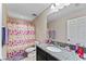 Cheerful bathroom with colorful shower curtain and granite vanity at 19065 Malinche Loop, Spring Hill, FL 34610