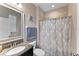 Clean bathroom with shower, granite vanity, and decorative shower curtain at 19065 Malinche Loop, Spring Hill, FL 34610