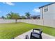 Private backyard with grassy lawn and patio seating at 19065 Malinche Loop, Spring Hill, FL 34610