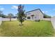 Spacious backyard with grassy lawn and privacy fence at 19065 Malinche Loop, Spring Hill, FL 34610