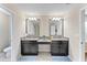 Double vanity bathroom with granite countertops and mirrors at 19065 Malinche Loop, Spring Hill, FL 34610