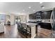 Open concept kitchen with island, granite countertops, and stainless steel appliances at 19065 Malinche Loop, Spring Hill, FL 34610