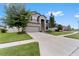 Two-story house with gray siding, stone accents, and a three car garage at 19065 Malinche Loop, Spring Hill, FL 34610