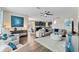 Spacious living room with sectional sofa and large TV at 19065 Malinche Loop, Spring Hill, FL 34610
