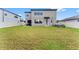 Large backyard with view of home's back elevation at 19065 Malinche Loop, Spring Hill, FL 34610