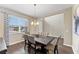 Bright dining room with hardwood floors, chandelier, and modern table at 19065 Malinche Loop, Spring Hill, FL 34610
