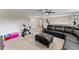 Relaxing loft with sectional sofa, exercise bike, and ceiling fan at 19065 Malinche Loop, Spring Hill, FL 34610