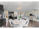 Bright dining area with a round table and chairs, and hardwood floors at 19065 Malinche Loop, Spring Hill, FL 34610