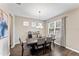 Bright dining room with hardwood floors, chandelier, and modern table at 19065 Malinche Loop, Spring Hill, FL 34610