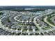 Aerial view of a large community with houses, lakes, and roads at 19065 Malinche Loop, Spring Hill, FL 34610