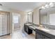 Double vanity bathroom with granite countertops at 19065 Malinche Loop, Spring Hill, FL 34610