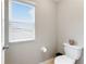 Small bathroom with toilet and window at 19065 Malinche Loop, Spring Hill, FL 34610