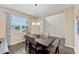 Bright dining room features a dark wood table with gray chairs and a chandelier at 19065 Malinche Loop, Spring Hill, FL 34610
