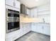 Modern kitchen with double oven, stainless steel appliances, and white cabinets at 920 N Osceola Ave # 703, Clearwater, FL 33755