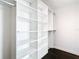 Bright white closet with custom built-in shelving and rods at 920 N Osceola Ave # 703, Clearwater, FL 33755