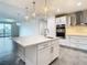 Modern kitchen with white island, stainless steel appliances, and quartz countertops at 920 N Osceola Ave # 703, Clearwater, FL 33755