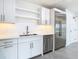 White shaker cabinets, stainless steel appliances, and quartz countertops in this kitchen at 920 N Osceola Ave # 703, Clearwater, FL 33755