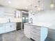 Modern kitchen with white cabinets, stainless steel appliances, and a large island at 920 N Osceola Ave # 703, Clearwater, FL 33755