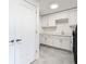 Bright laundry room with white cabinets and a utility sink at 920 N Osceola Ave # 703, Clearwater, FL 33755