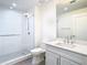 Modern bathroom with a glass shower, white vanity, and gray tile floor at 920 N Osceola Ave # 703, Clearwater, FL 33755
