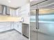 Modern kitchen with white cabinets, stainless steel appliances and a large refrigerator at 920 N Osceola Ave # 703, Clearwater, FL 33755