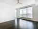 Bright bedroom with dark hardwood floors, large windows, and a ceiling fan at 920 N Osceola Ave # 703, Clearwater, FL 33755