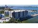 Aerial view of a modern waterfront condo building with a pool and parking at 920 N Osceola Ave # 703, Clearwater, FL 33755