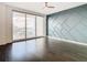 Bright bedroom with dark hardwood floors, city view, and a modern accent wall at 920 N Osceola Ave # 703, Clearwater, FL 33755