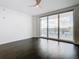 Bedroom with hardwood floors and sliding doors leading to a balcony with city views at 920 N Osceola Ave # 703, Clearwater, FL 33755
