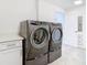 Functional laundry room with washer, dryer, and storage at 920 N Osceola Ave # 703, Clearwater, FL 33755
