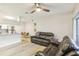 Bright living room with hardwood floors and a ceiling fan at 13113 Sanctuary Cove Dr # 104, Temple Terrace, FL 33637