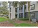 Exterior view of building showcasing stairs and screened patios at 13113 Sanctuary Cove Dr # 104, Temple Terrace, FL 33637