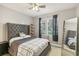 Serene bedroom with a ceiling fan and large window at 13113 Sanctuary Cove Dr # 104, Temple Terrace, FL 33637