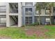 Exterior view showing building with stairs and screened patios at 13113 Sanctuary Cove Dr # 104, Temple Terrace, FL 33637