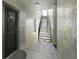 Interior hallway with dark door and metal staircase at 13113 Sanctuary Cove Dr # 104, Temple Terrace, FL 33637