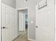 Bright hallway with two white doors and wood-look flooring at 13113 Sanctuary Cove Dr # 104, Temple Terrace, FL 33637